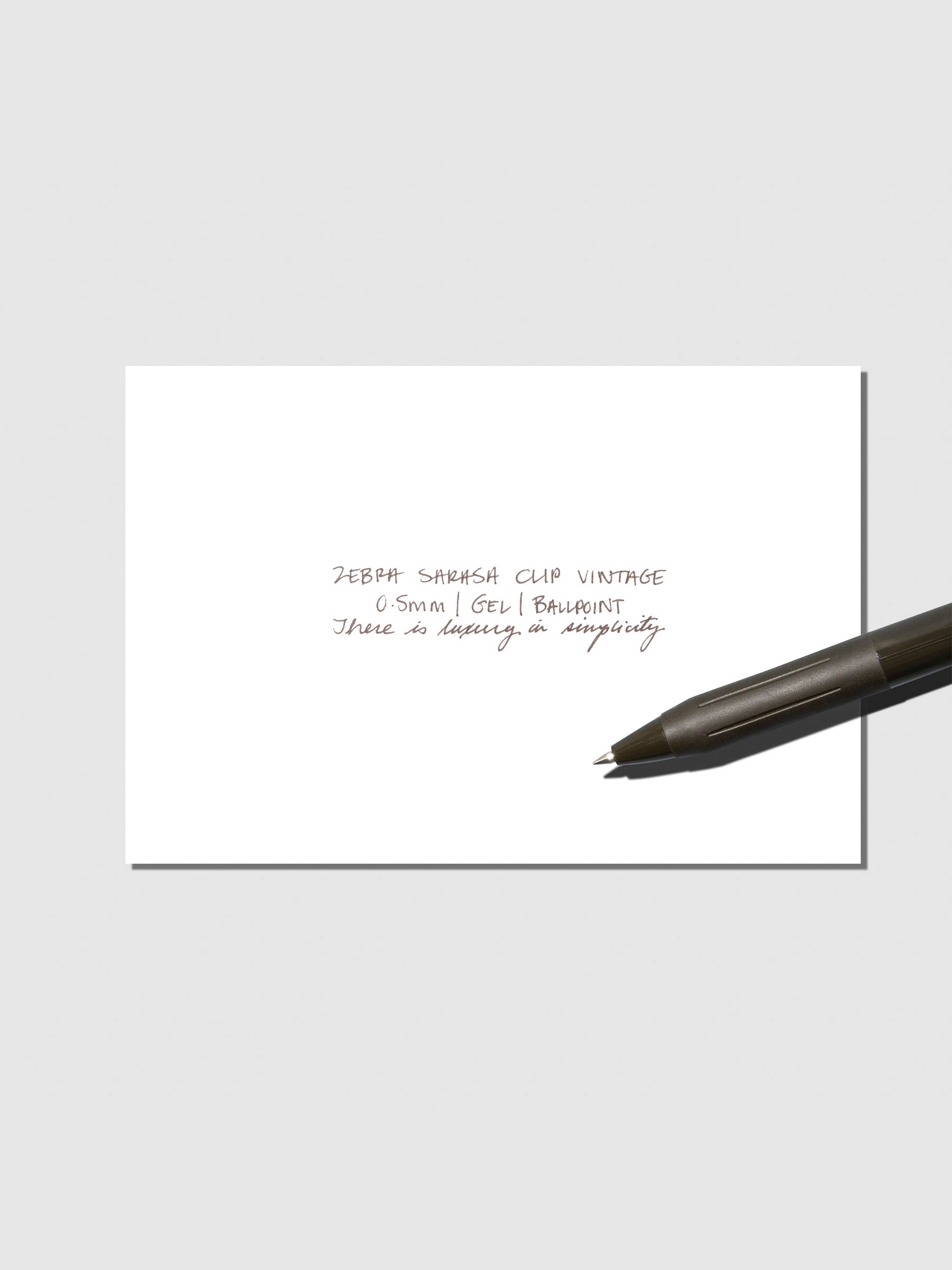 Pen testing sheet displayed with pen on a neutral background. Color shown is Sepia Black.
