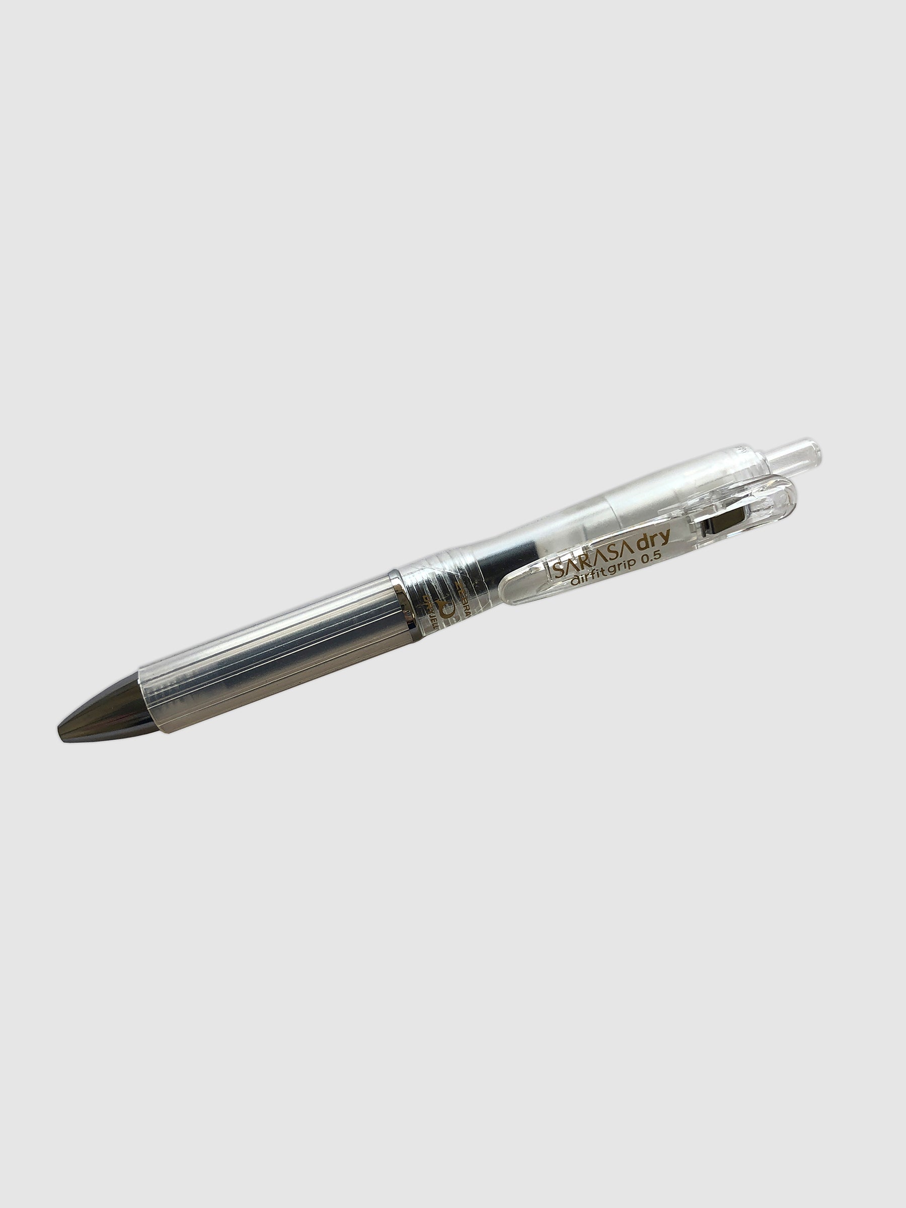 Zebra Sarasa Dry Airfit Grip Rollerball Pen, Clear, 0.5mm, Cloth & Paper. Pen turned to the left against a neutral background.