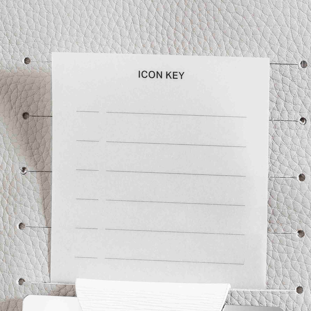 Icon Key journaling card displayed inside an Ash leather planner.