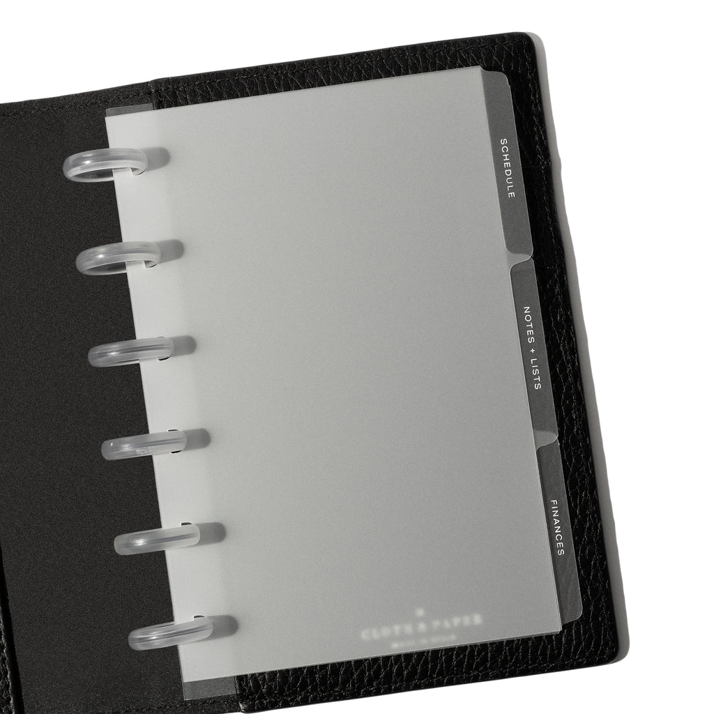 White  tab dividers displayed inside a black leather folio.