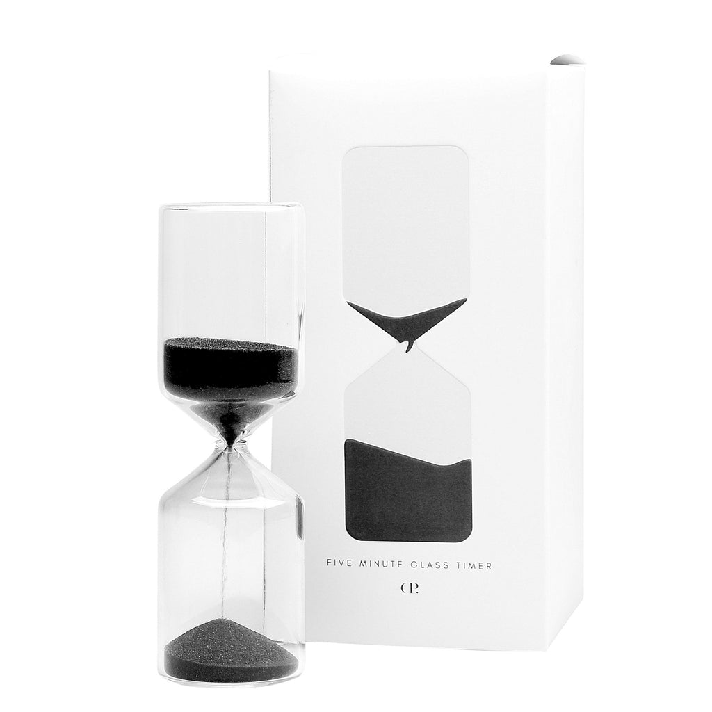 Timer displayed next to its packaging on a white background. Some sand is visible falling through the top of the timer to the bottom.