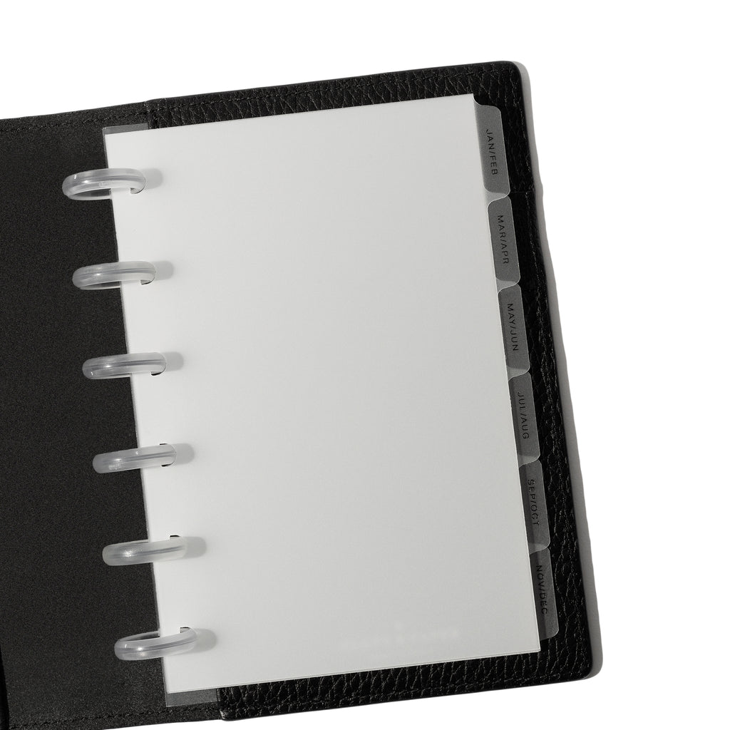 Black foil tabs displayed in use inside a black leather folio.