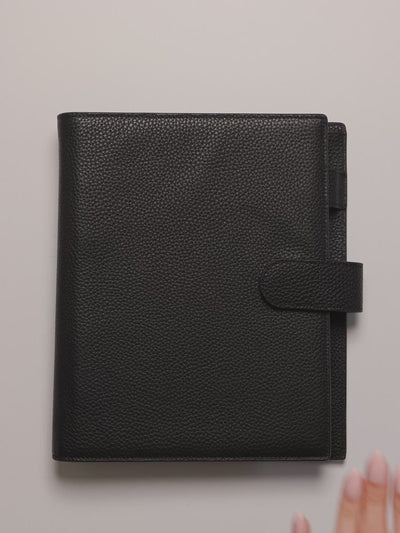 Opening an A5 black leather agenda and showing the Monthly Graph Planner Inserts.