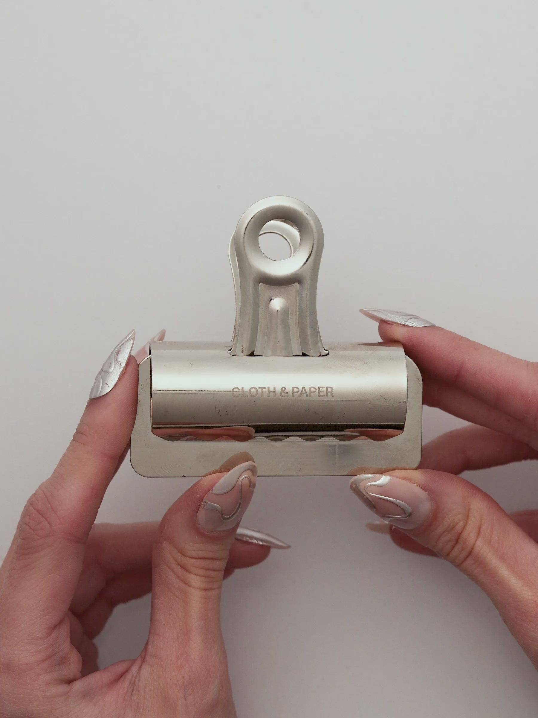 A video showing the Notebook Clip being used to hold pages together in a notebook. 