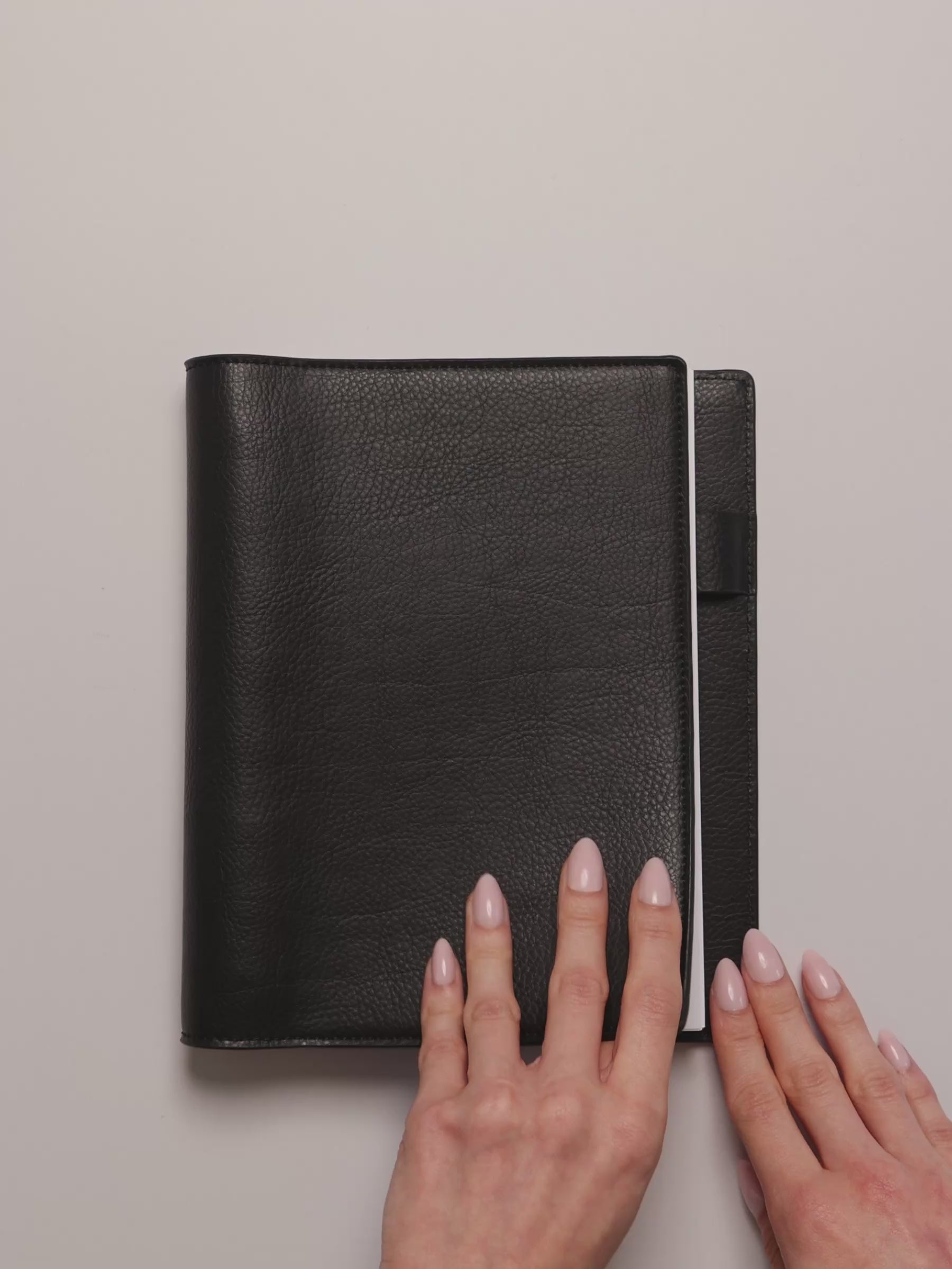 Opening a black leather folio to display the Undated Weekly Notes Planner Inserts.
