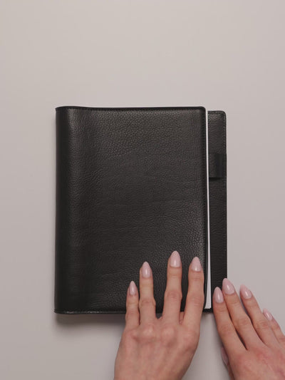 Opening a black leather folio to display the Undated Weekly Notes Planner Inserts.