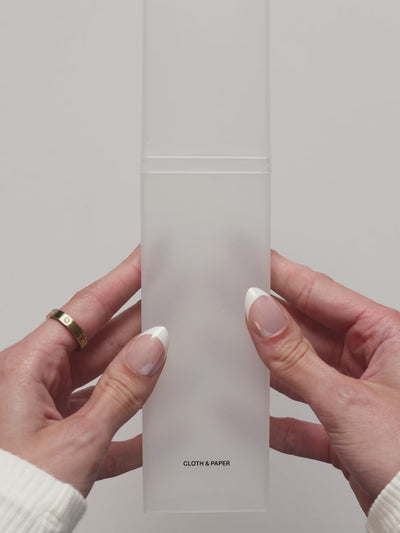 Video showing the frosted pencil box being opened and filled with writing tools. 