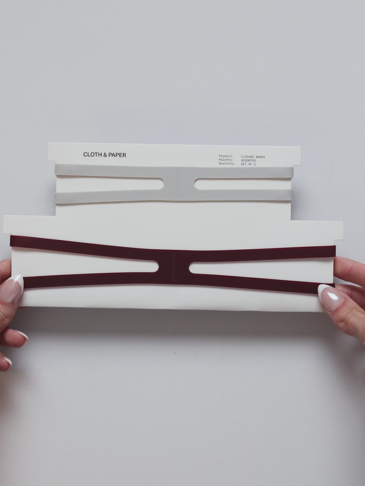 Video showing the planner closure bands being displayed in different colors, stretched to demonstrate flexibility, and wrapped around planners to keep them securely closed.