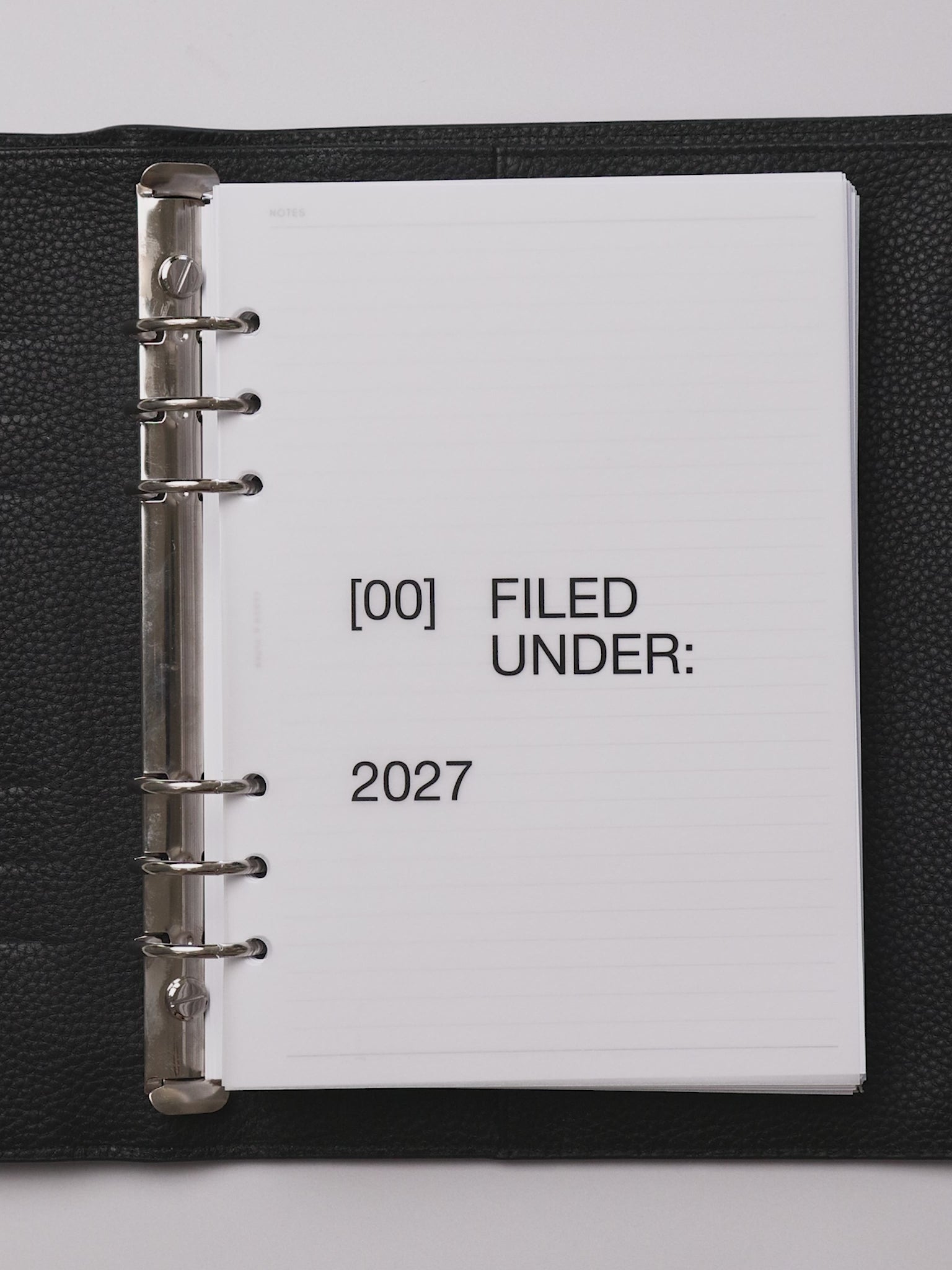A planner flip through featuring the 2027 Front + Monthly Dashboard Overlays in the color Avant Garde