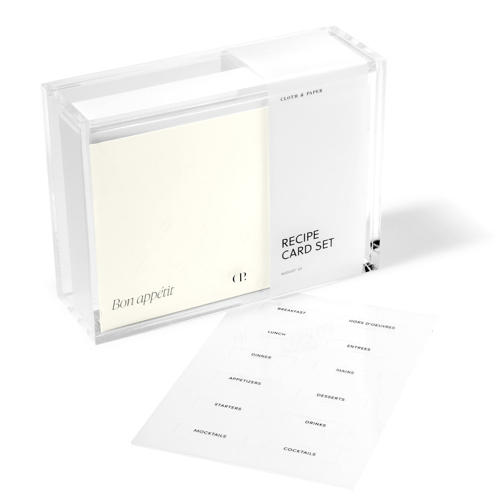 Recipe storage box in packaging displayed next to a set of label stickers on a white background. 