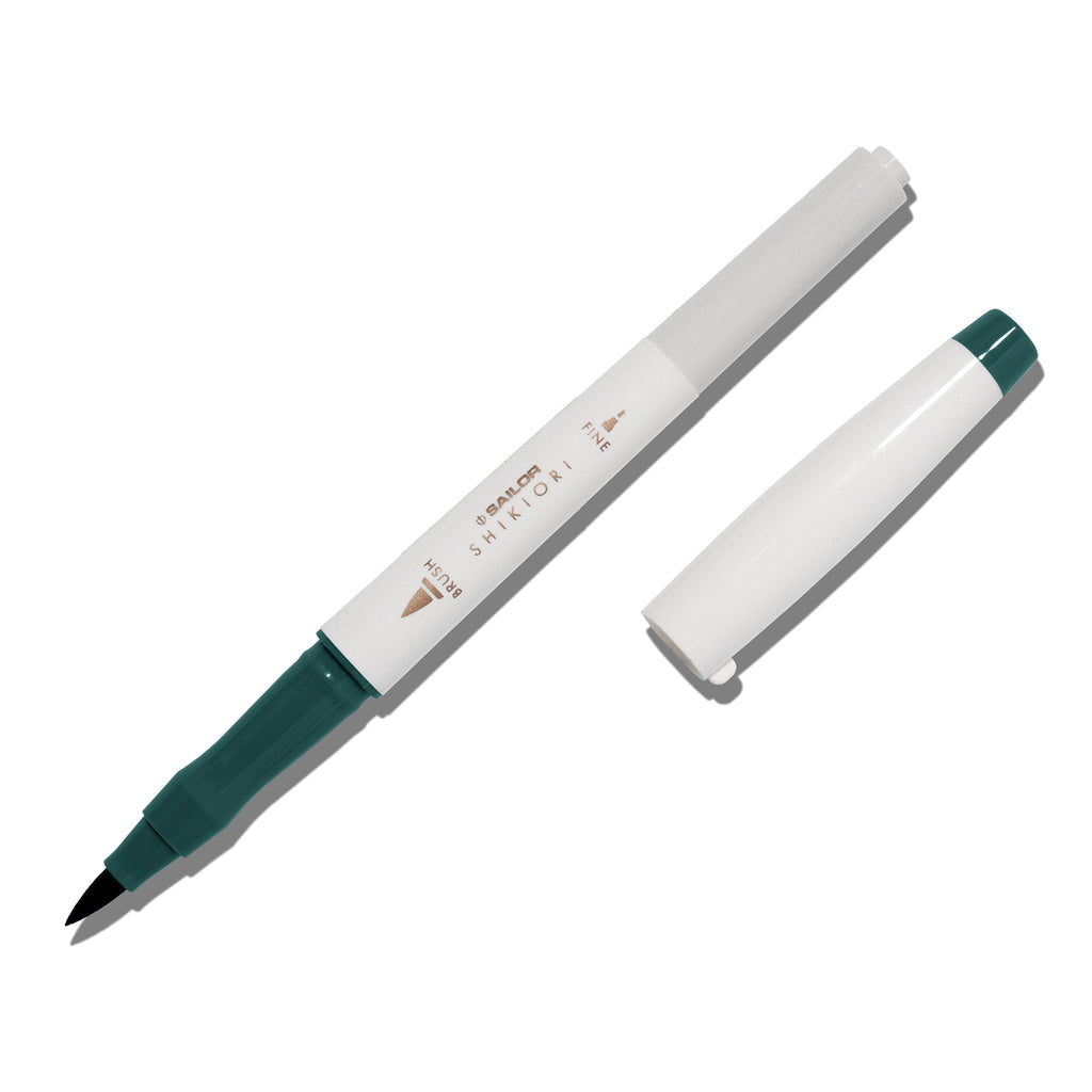 Brush pen displayed on a white background. It is uncapped with its brush nib exposed, and the cap lying parallel to the marker. Color pictured is Miruai. 
