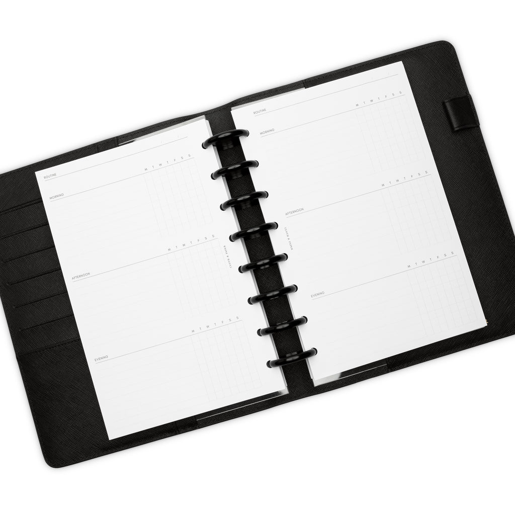 Insert in use inside a black discbound planner agenda system. Spread displays two days' worth of morning, afternoon, and evening routines.