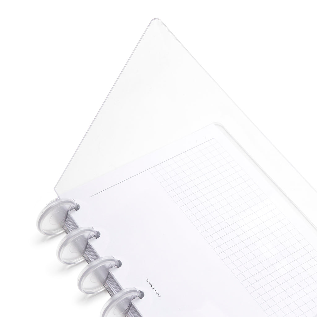 Crystal Clear Discbound Notebook Cover, HP Mini, Cloth and Paper. Close up image of notebook covers in use with clear rings and an insert. The front cover is opened halfway.
