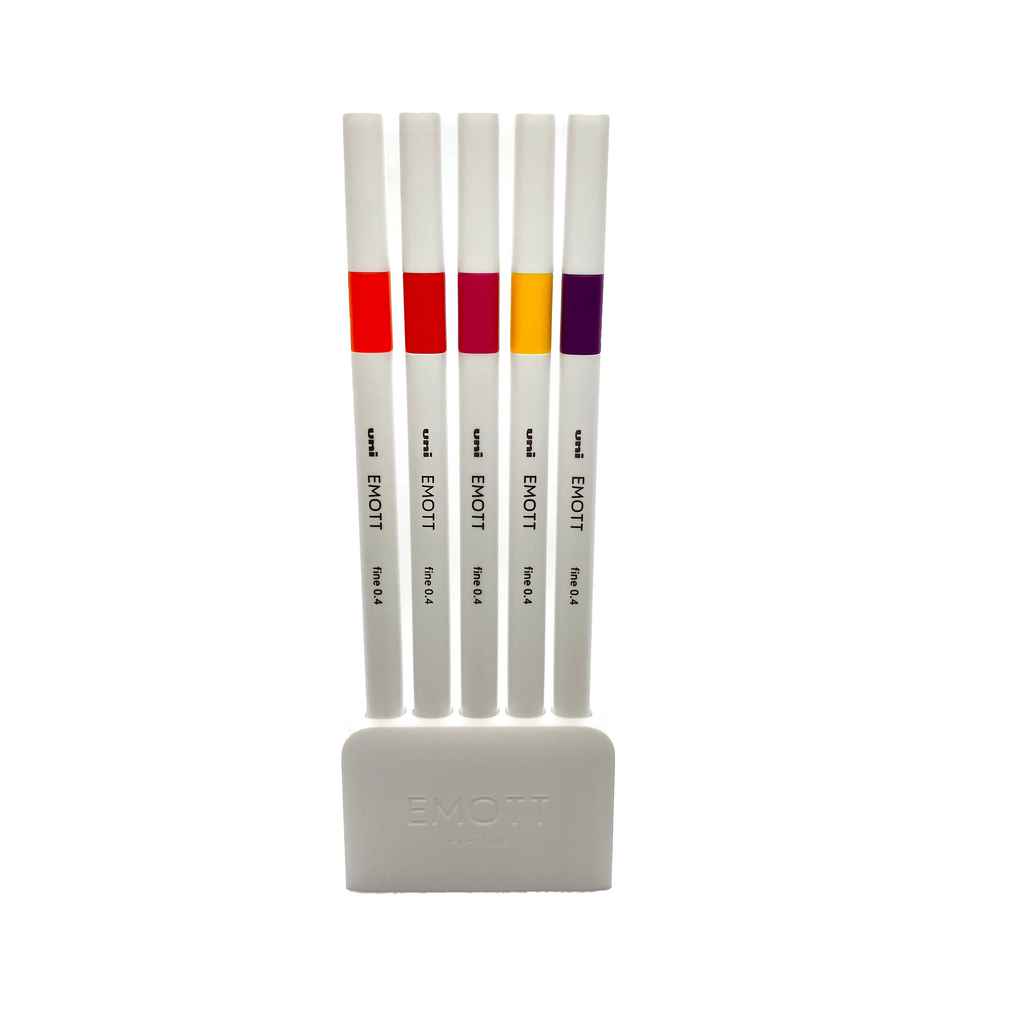 Uni EMOTT Ever Fine, 5 Color Set No. 2, Passion, Cloth and Paper. Pens resting in their pen stand against a white background.