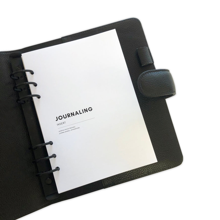 Cover page of Journaling inserts in use inside a black leather agenda.