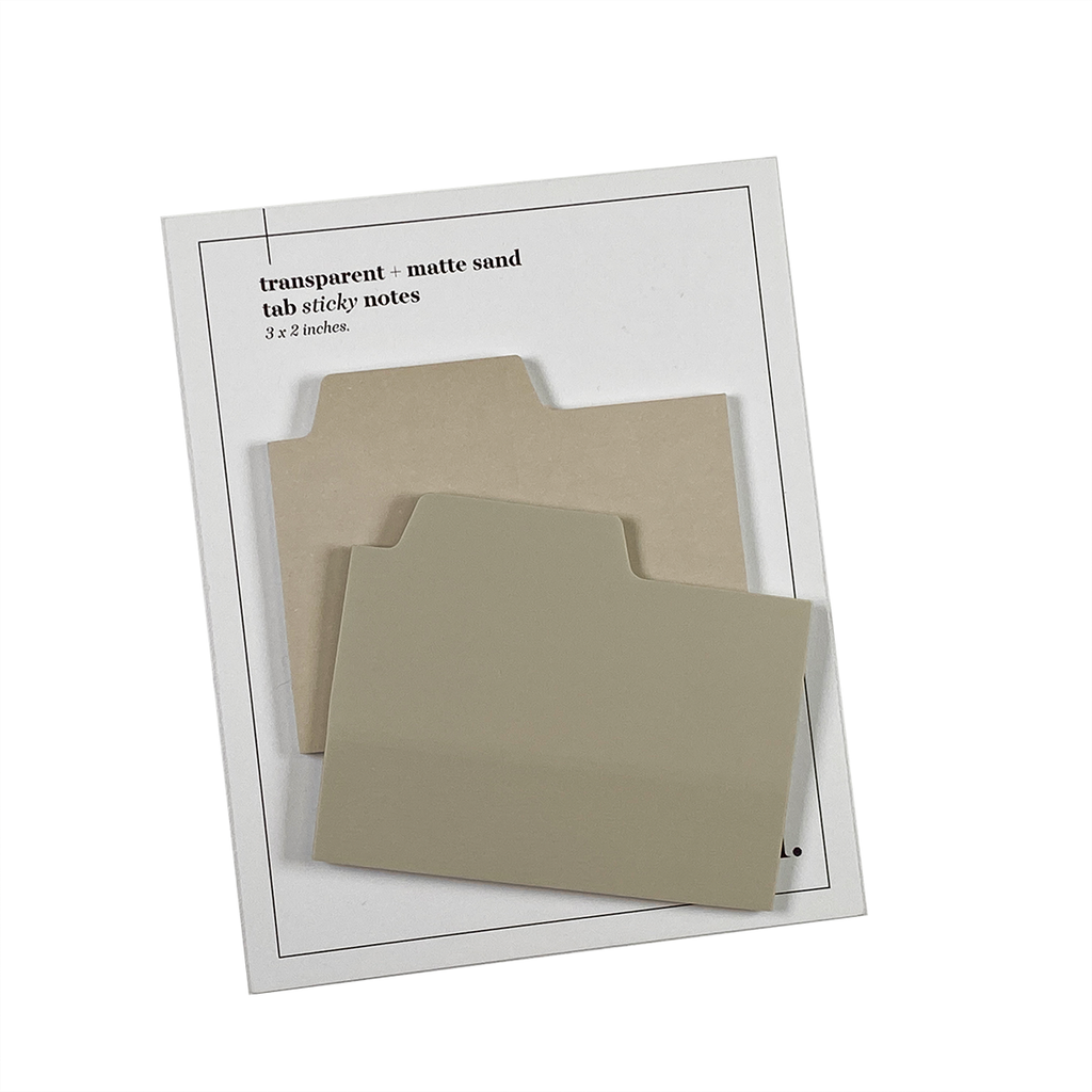 Blank Tab Sticky Note Set, Sand, Cloth and Paper. Sticky note set displayed against a white background. The matte sticky note pad is attached to the sticky note backing, while the transparent sticky note pad is layered on top of it, turned slightly to the right.
