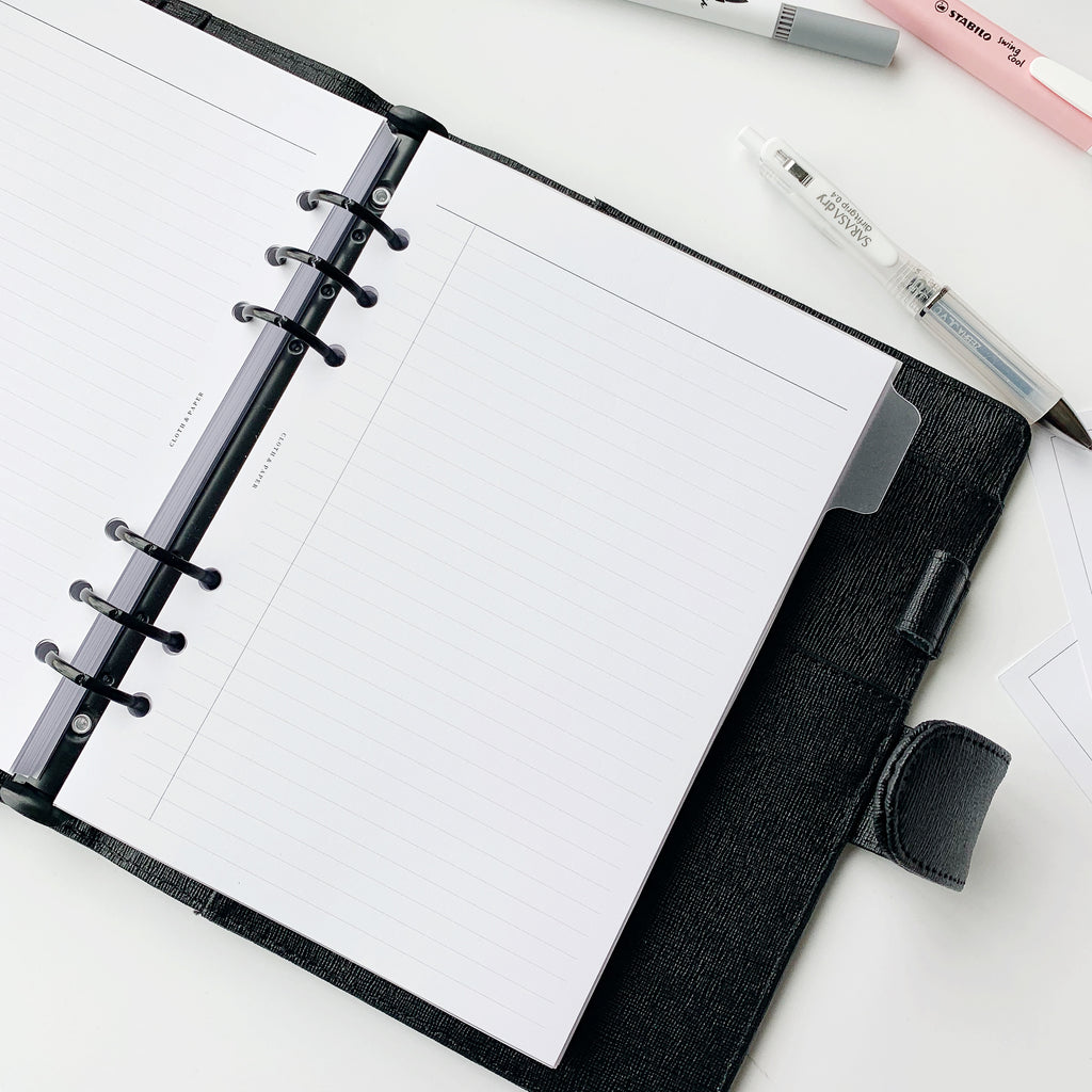 Task Planner Inserts styled inside a black leather agenda with black rings.
