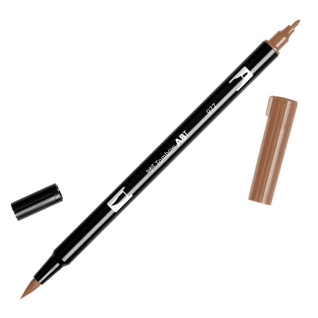 Tombow Dual Brush Art Marker, Saddle Brown, Cloth & Paper. Art marker turned slightly to the right on a white background. It is uncapped on both ends showing the brush tip and fine tip.