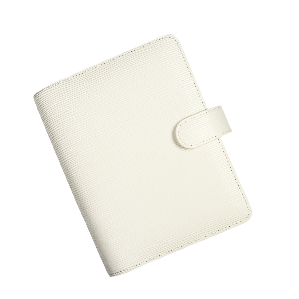 Agenda Cover in Small Size with White Contoured Leather closed to show the front. The cover is turned to the left against a white background.