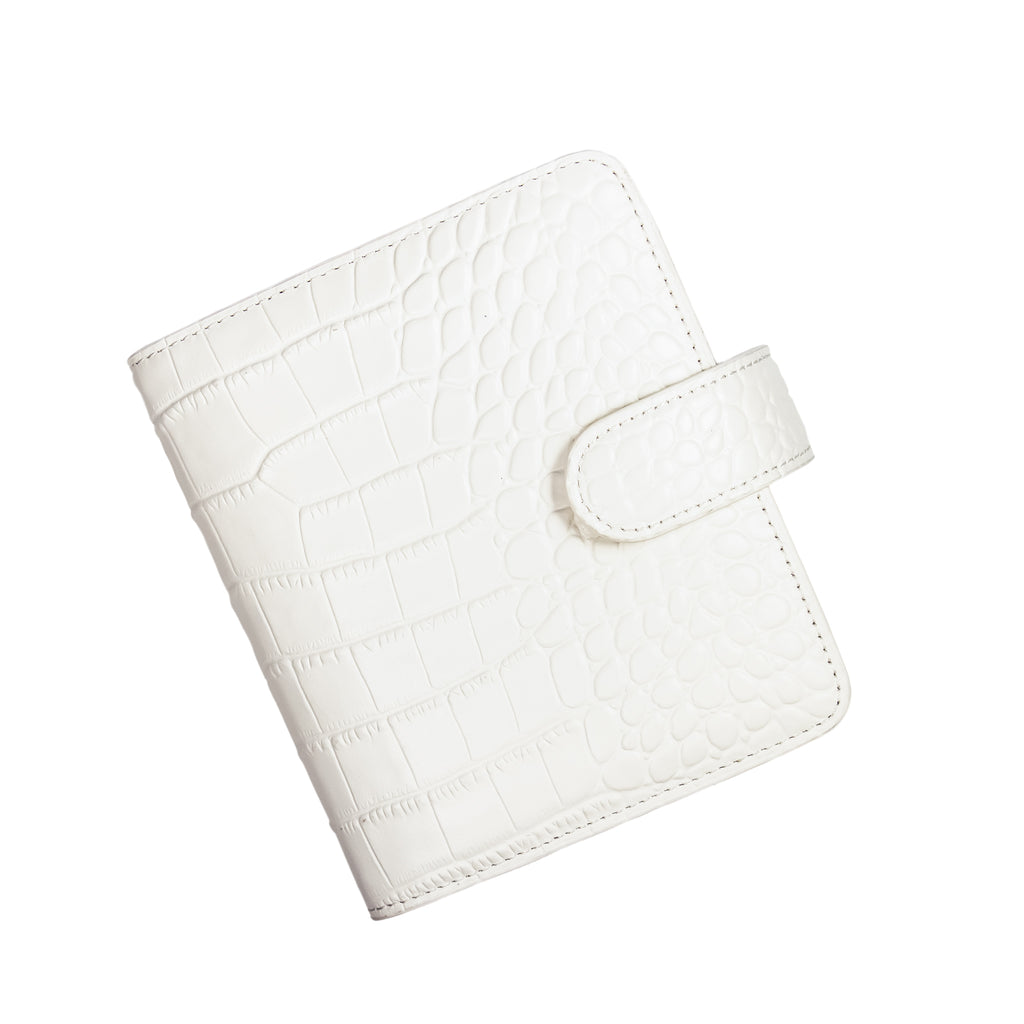 6-Ring Agenda in Pocket Size with White Croc Leather closed to show the front cover. The agenda is turned to the left against a white background.
