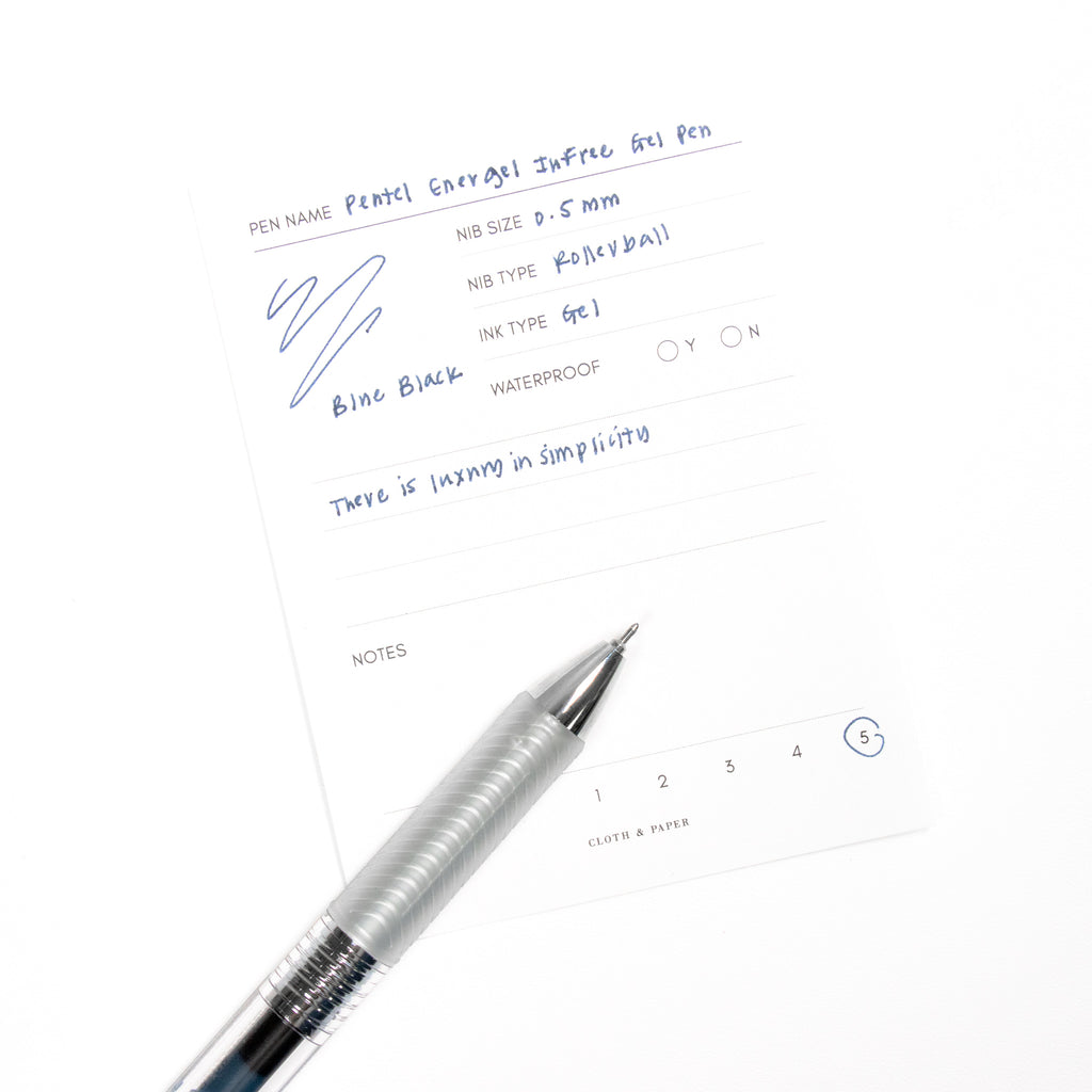 Pentel Energel Infree Gel Pen, Blue-Black, Cloth and Paper. Pen resting on pen test sheet displaying writing sample.