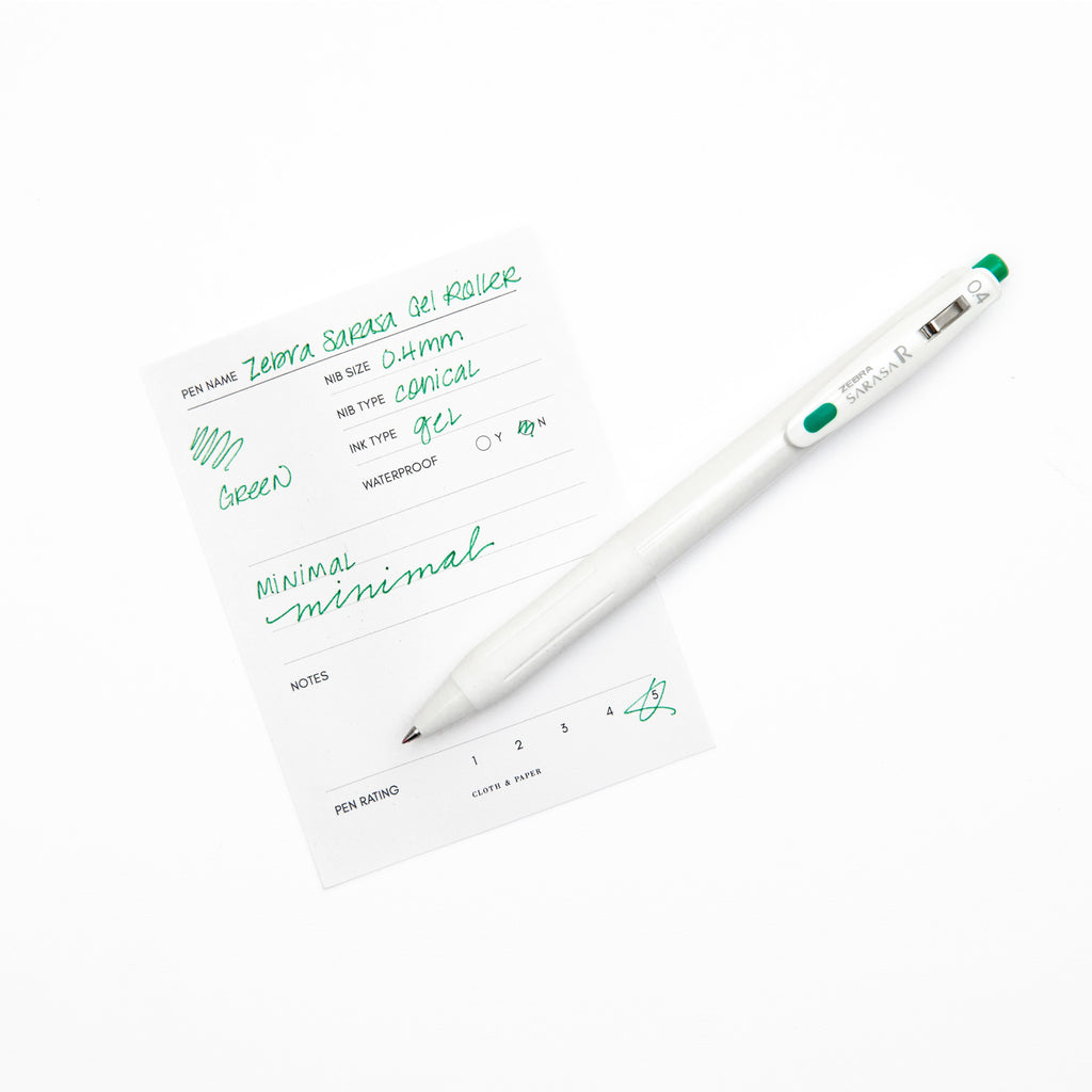 Zebra Sarasa R Pen, 0.4 mm, Green, Cloth and Paper. Pen resting on pen test sheet displaying writing sample.